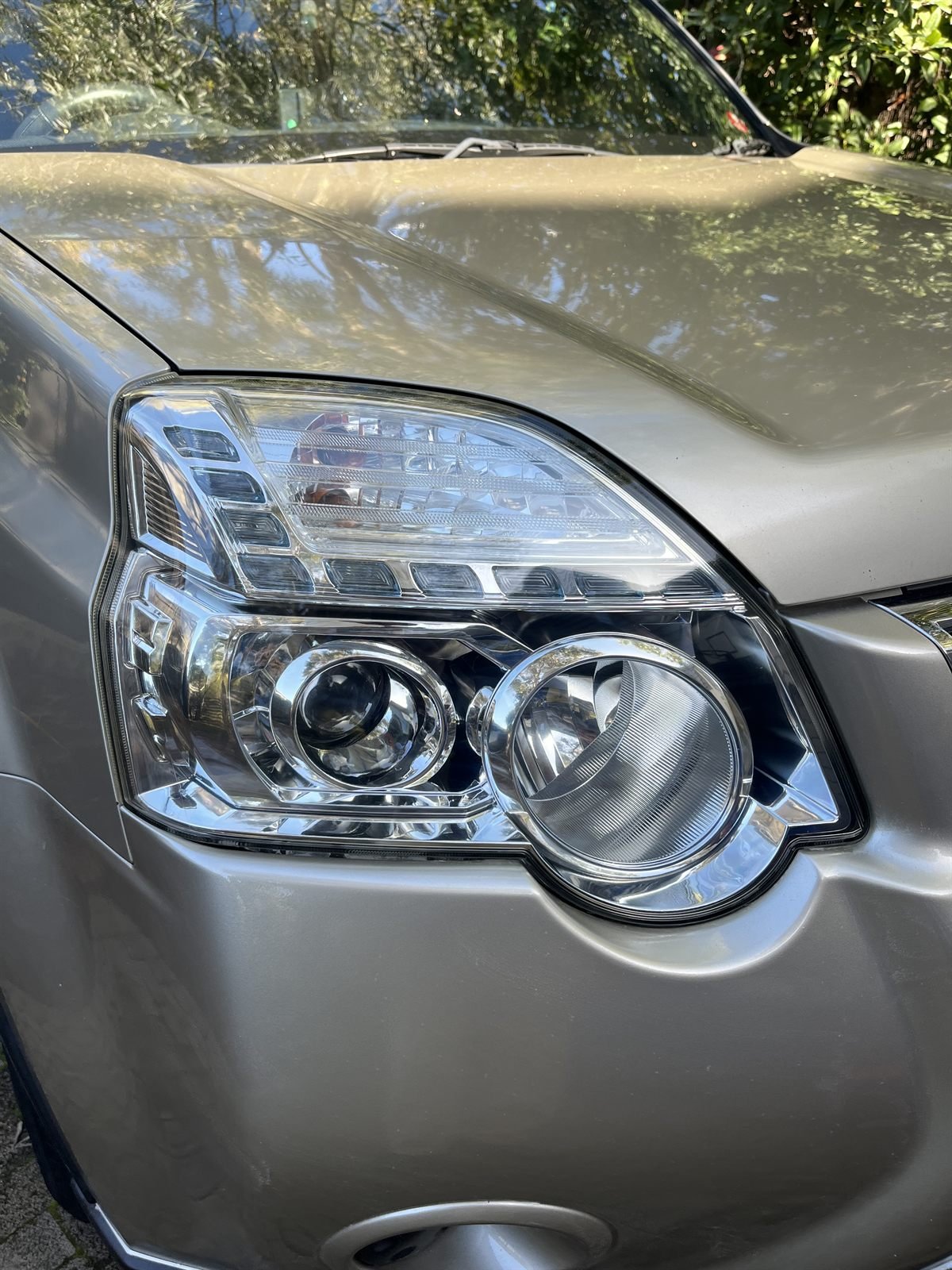 Nissan X-Trail headlight after restoration — clear and restored